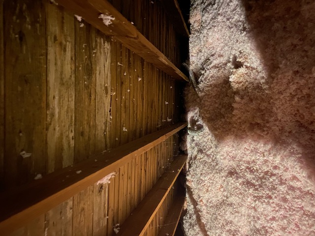 Attic insulation checked during an air quality inspection