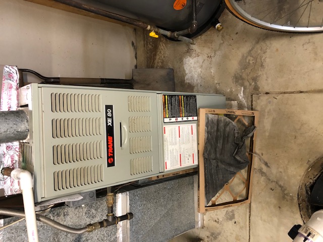 Clogged furnace filter removed during service
