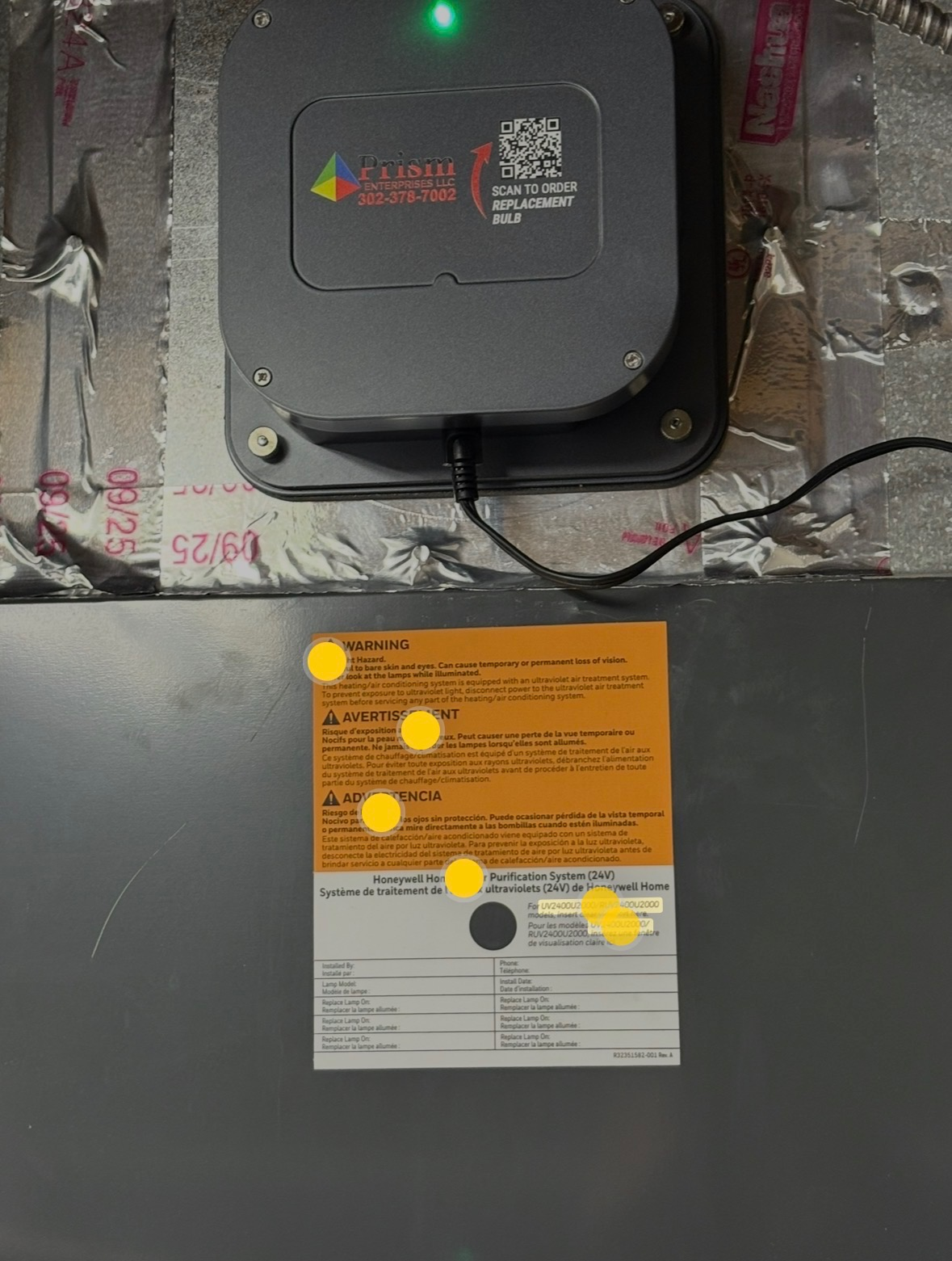 UV air purification unit installed on an HVAC system with Prism Enterprises branding