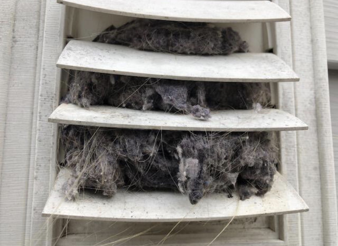 Exterior dryer vent louvers packed with lint before cleaning