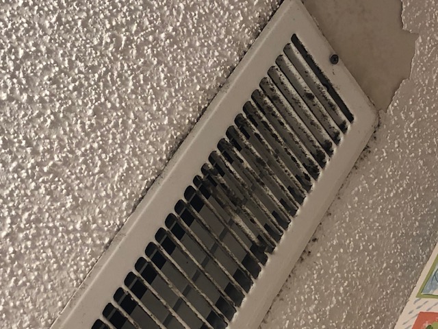 Dirty ceiling supply vent before duct cleaning